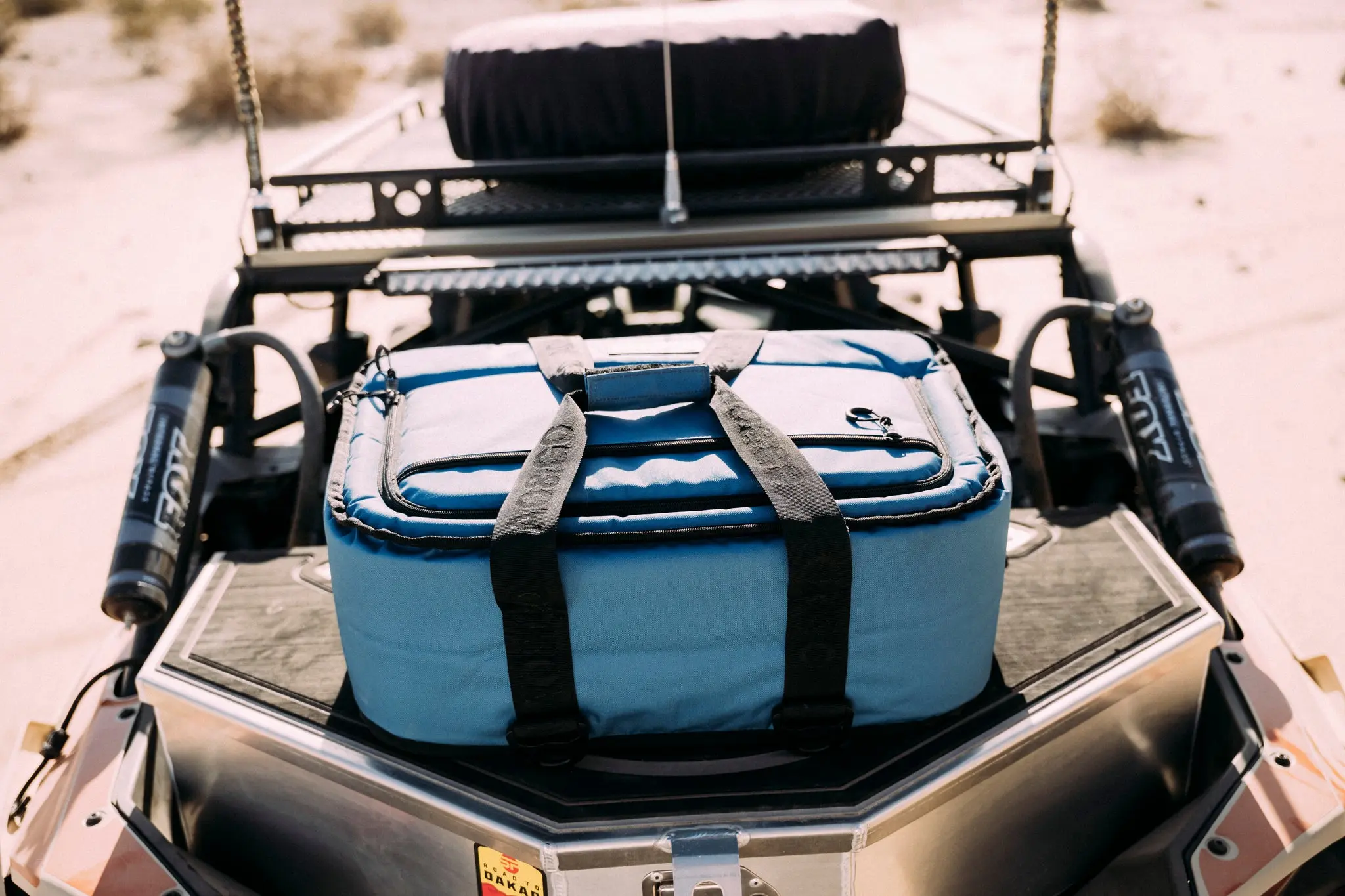 Blue AO cooler secured to an off-road vehicle